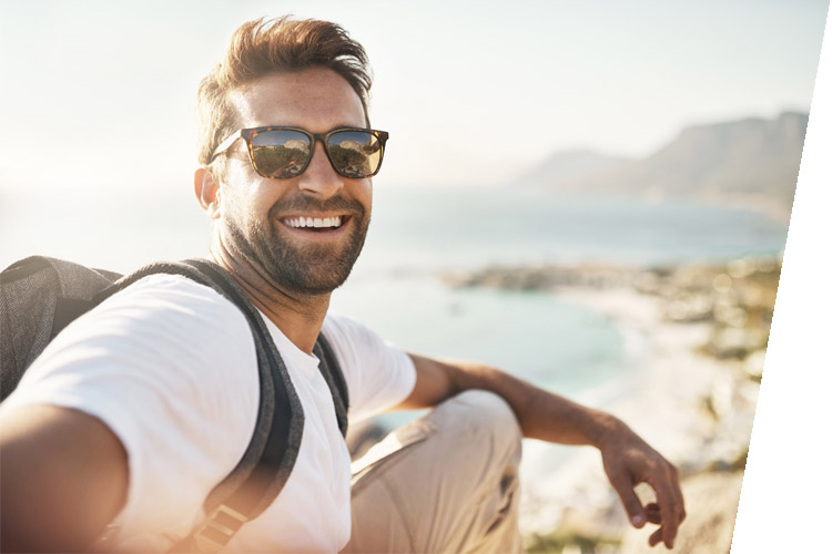 selfie of man in sunglasses at the beach